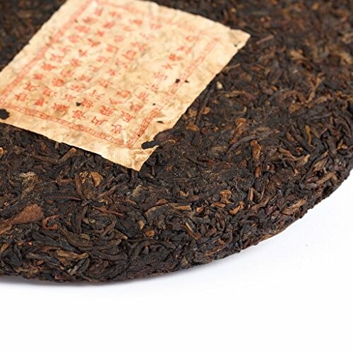 Close-up of a compressed tea brick with a label.