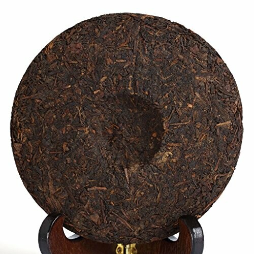 Round compressed tea cake on stand